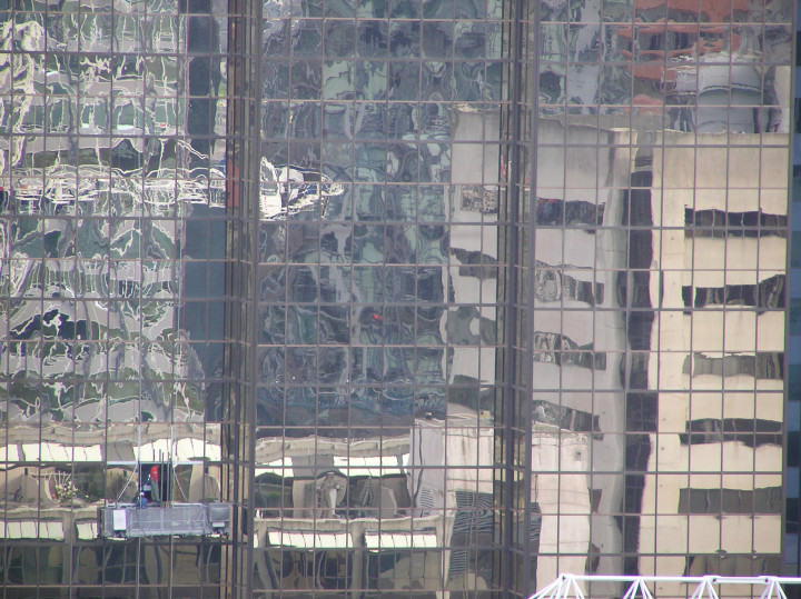 Photo
              of multiple urban reflections as visual allusion to the
              confusion caused by metaphor