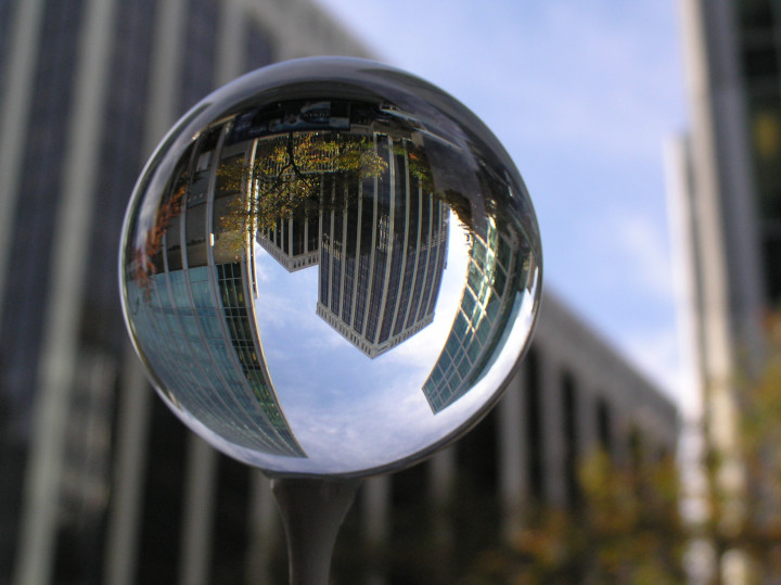 Photo of city buildings
                                          viewed through a glass golf
                                          ball