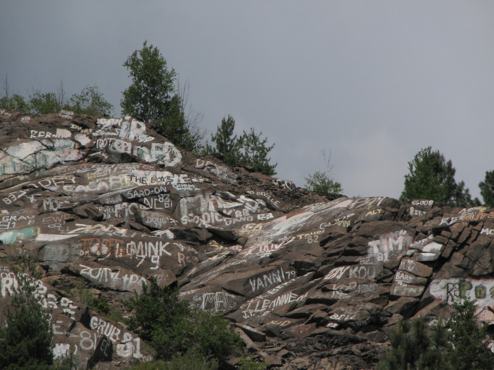 Photo of
                rocky outcroppings covered with graffiti