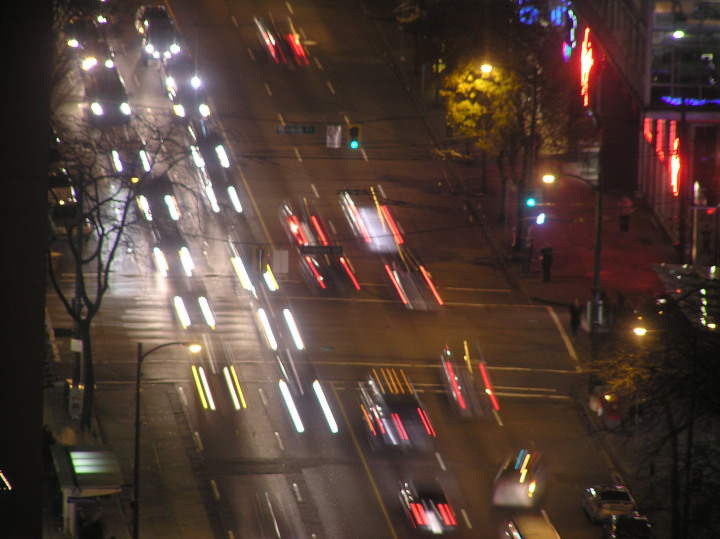 Photo of a
              city street at night with cars going both ways