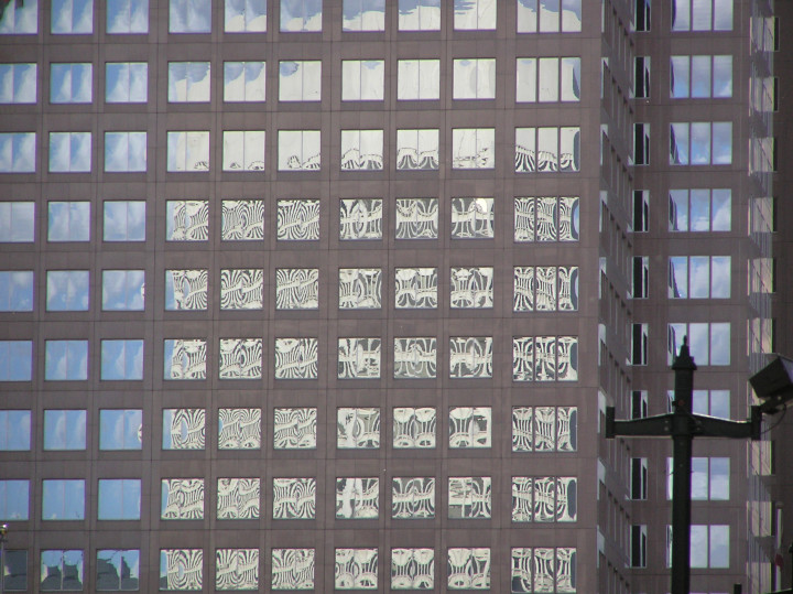 Photo of of
                a high-rise office building with a repetitious grid of
                windows