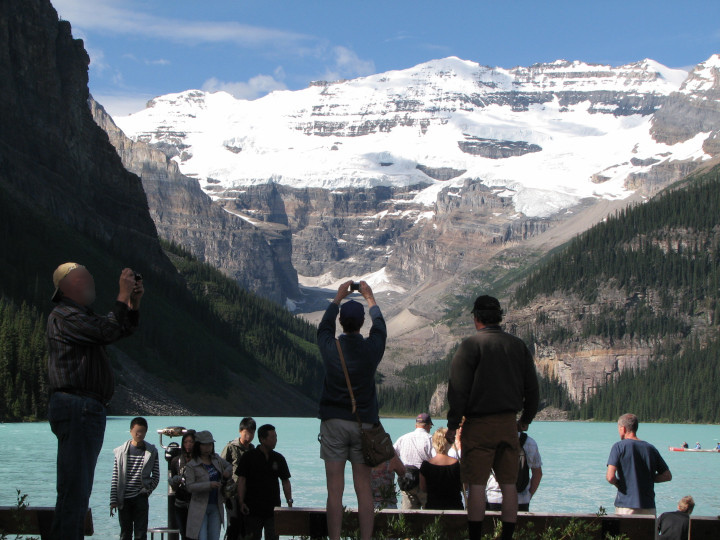 Photo of part of
              a crowd taking photos of themselves on the shore of Lake
              Louise