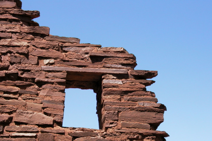 Photo of a window
          opening in abandoned ruin with a wall fragment surrounding